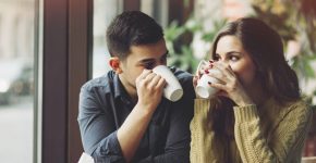 Couple in love drinking coffee and have fun in coffee shop. Love concepts. Vintage effect style picture
