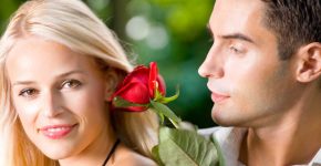 Funny young happy couple with rosa, outdoors
