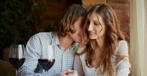 Portrait of amorous young couple flirting in restaurant