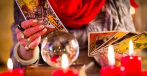 Female Fortuneteller or esoteric Oracle, sees in the future by playing her tarot cards during a Seance to interpret them and to answer questions