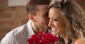 Young happy couple having romantic date at restaurant - drinking wine and eating gourmet food